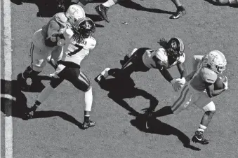  ?? [BRIANNA PACIORKA/NEWS SENTINEL] ?? Tennessee running back Eric Gray (3) escapes a tackle attempt by Missouri linebacker Nick Bolton (32) during the Volunteers' 35-12 win Oct. 3 in Knoxville.