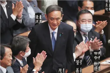  ?? (AP Photo/Koji Sasahara, File) ?? In this Sept. 16, 2020, file photo, Yoshihide Suga is applauded after being elected as Japan's new prime minister at parliament's lower house in Tokyo. Japan's new Prime Minister Suga heads to Vietnam and Indonesia on Sunday, Oct. 18, 2020, on his first overseas foray since taking over from his former boss Shinzo Abe last month.