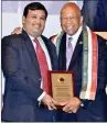  ??  ?? Subramanya K. Kusnur receives the award from US Congressma­n, Elijah Cummins.