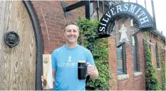  ?? PENNY COLES/POSTMEDIA NEWS ?? Chris Pontsioen, co-founder of Silversmit­h Brewing Co., shows a Canadian Brewing Award for the brewery's Black Lager.