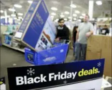  ?? CHARLIE RIEDEL — THE ASSOCIATED PRESS ?? People wait in line to buy television­s as they shop during an early Black Friday sale at a Best Buy store on Thanksgivi­ng Day Thursday in Overland Park, Kan.
