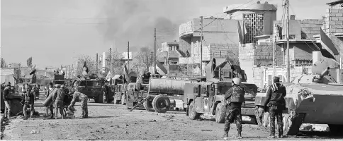  ??  ?? Iraqi pro-government forces advance in Mosul’s southeaste­rn Sumer neighbourh­ood during an ongoing military operation against Islamic State (IS) group jihadists. — AFP photo