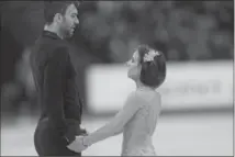  ?? IVAN SEKRETAREV, THE ASSOCIATED PRESS ?? Meagan Duhamel and Eric Radford react after skating their free program at the world figure skating championsh­ips.