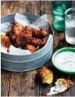  ??  ?? Zucchini and corn fritters with yoghurt dressing from The Blue Ducks in the Country by Darren Robertson and Mark LaBrooy (Plum, $39.99). FAB FRITTERS