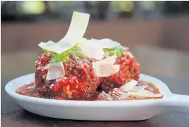  ?? AMY BETH BENNETT/SUN SENTINEL ?? What’s the secret to making a turkey meatball that outranks a traditiona­l meatball? Adobo seasoning and white wine are key ingredient­s for Tommy’s turkey meatballs at B Square Burgers & Booze in Fort Lauderdale.
