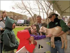  ?? SUBMITTED ?? Event manager Andy McGovern holds a young goat, called a kid, during Penitentia­ry Glen’s Earth Day celebratio­n as visitors look on. The Lake Metroparks property will host 2017 Earth Day April 23 from noon to 4 p.m.