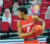  ?? COURTESY OF UNM ATHLETICS ?? Saquan Singleton looks to get the ball to a Lobo teammate during the first half of UNM’s road loss at UNLV on Monday night.