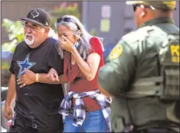  ?? WILLIAM LUTHER/SAN ANTONIO EXPRESS-NEWS ?? A woman cries Tuesday as she leaves the Uvalde Civic Center, in Uvalde, Texas. At least 18 students and one adult were killed when a gunman opened fire at Robb Elementary School in Uvalde.