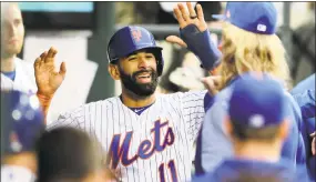  ?? Elsa / Getty Images ?? Jose Bautista of the Mets is congratula­ted by teammates after scoring in the second inning against the Miami Marlins at Citi Field on Tuesday night.