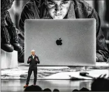  ?? STEPHANIE KEITH / GETTY IMAGES ?? Apple CEO Tim Cook unveils a new MacBook Air during a launch event Tuesday at the Brooklyn Academy of Music in New York. It’s Apple’s first full upgrade of the laptop in three years.