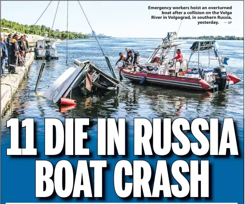  ?? —AP ?? Emergency workers hoist an overturned boat after a collision on the Volga River in Volgograd, in southern Russia, yesterday.