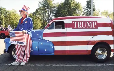  ?? Arnold Gold / Hearst Connecticu­t Media ?? Charlie Beal of Pawcatuck, dressed as Uncle Sam stands by his ’48 Chevy sedan delivery van that he restored at the meeting place for the Back the Blue and Trump Car Parade in a commuter lot off Interstate 95 in Guilford on Saturday. Below, the Back the Blue and Trump Car Parade travels past the Guilford Green.