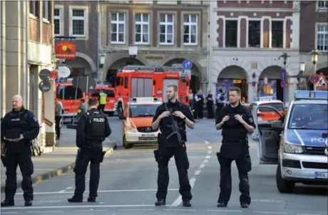  ?? FERDINAND OSTROP — THE ASSOCIATED PRESS ?? Police officers respond after a van crashed into a group of people at a popular bar in Muenster, Germany, killing at least three.