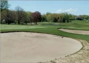  ??  ?? Two of the four sand traps that surround the 11th-hole green at Van Patten.