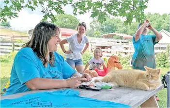  ?? — The Washington Post photo ?? Renee Small, left, shares a laugh with her daughter-in-law Taylor Small; her grandson, Ryan Small, 20 months; and farm volunteer Alyssa Conrad, right.