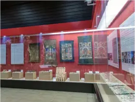  ?? (Photo by VCG) ?? Pictured is an exhibition of artifacts and paintings concerning the rituals of the Naxi ethnic group at Lijiang Museum, April 6, 2023