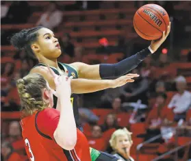  ?? Rick Bowmer / Associated Press ?? Satou Sabally, who scored a gamehigh 23 points, soars over Utah’s Andrea Torres in the second quarter of No. 3 Oregon’s 9063 victory in Salt Lake City.