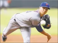  ?? Curtis Compton / TNS ?? Jacob deGrom delivers a pitch against Atlanta during the first inning on Wednesday.