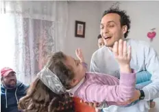  ?? — AFP ?? Photojourn­alist Mahmoud Abu Zeid, widely known as Shawkan, plays with his niece at his home in Cairo on Monday.