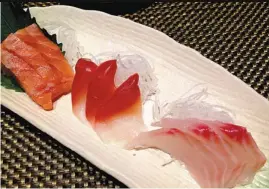  ?? PHOTOS BY JU CHUANJIANG / CHINA DAILY ?? Miyabi’s sashimi offerings include salmon, lipstick clam and snapper. Its grilled oysters (top), covered with light miso, are also highly recommende­d.