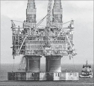  ?? CP FILE PHOTO ?? A tug positions itself near the base of the Hibernia platform in Bull Arm, Trinity Bay, on May 22, 1997. Newfoundla­nd and Labrador’s highest court has upheld a decision to reinstate an offshore oil worker who was fired after he tested positive for...