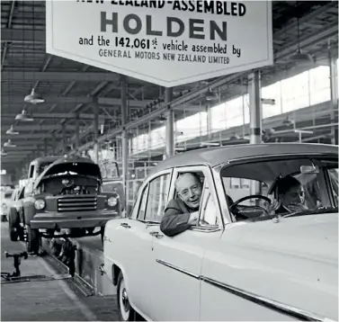  ?? NATIONAL LIBRARY OF NZ ?? The first-ever New Zealandass­embled Holden rolls off the production line at General Motors’ Petone plant, in 1957.