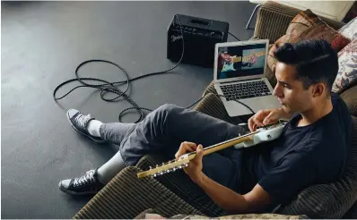  ?? (Fender/via Reuters) ?? A YOUNG MAN uses Fender Play, a new subscripti­on-based online system for learning guitar.