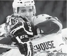  ??  ?? Victoria Royals’ Chaz Reddekopp consoles goaltender Griffen Outhouse after their epic Game 6 overtime loss to the Everett Silvertips in April.