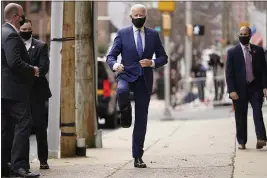  ?? ANDREW HARNIK — THE ASSOCIATED PRESS ?? President- elect Joe Biden raises his leg as he enters The Queen theater on Tuesday in Wilmington, Del.