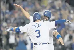  ?? JAE C. HONG — THE ASSOCIATED PRESS ?? The Dodgers’ Chris Taylor hugs Albert Pujols after his two-run home run against the Braves during the fifth inning in Game 5 of the National League Championsh­ip Series on Thursday in Los Angeles.