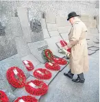  ??  ?? A member of the public, above, lays a wreath at Hyde Park Corner at the ceremony attended by Meghan Markle, left, and Prince Harry, top.