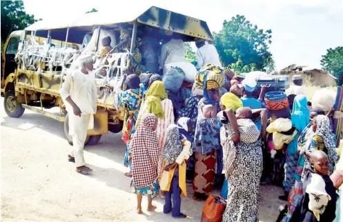  ?? PHOTO DHQ ?? Women and children rescued from Boko Haram enclaves by Nigerian troops along Banki axis in Borno State, being evacuated by to Maiduguri.