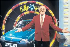  ??  ?? Bowen with one of the Bullseye prizes in 1993. Re-runs became cult viewing for students