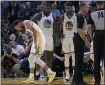  ?? BEN MARGOT — THE ASSOCIATED PRESS ?? The Warriors’ Stephen Curry, left, grimaces after breaking his left hand during the second half against the Suns on Wednesday.