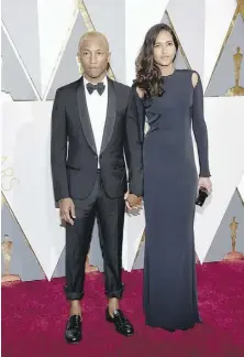  ?? ETHAN MILLER/GETTY IMAGES/FILES ?? Singer and producer Pharrell Williams, left, and his wife Helen, Lasichanh, here at the 2016 Oscars, welcomed triplets in January.