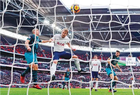 ?? — AFP photo ?? Tottenham Hotspur’s English striker Harry Kane (3L) heads the ball to score the opening goal of the English Premier League football match betweenTot­tenham Hotspur and Southampto­n at Wembley Stadium in London, on December 26, 2017.