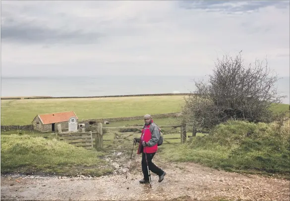  ??  ?? POWER OF LOVE: The Archbishop of York braves the Yorkshire weather on his pilgrimage. His new book explores real life stories that illustrate the idea of ‘Agape’ – the gracious and life-transformi­ng love of God.