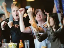  ?? Susana Bates / Special to The Chronicle 2012 ?? Peter Ellenby (right) and his brother Tom cheer at the Public House in San Francisco during a Giants game in 2012.