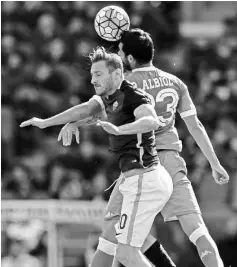  ??  ?? Napoli’s defender from Spain Raul Albiol (R) fights for the ball with Roma’s forward Francesco Totti during the Italian Serie A football match AS Roma vs Napoli on April 25, 2016 at the Olympic Stadium in Rome. - AFP photo