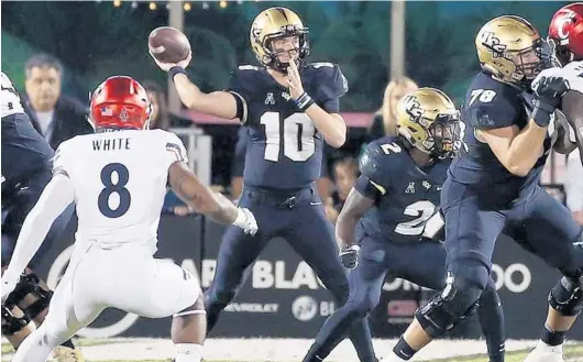  ?? PHOTOS BY STEPHEN M. DOWELL/ORLANDO SENTINEL ?? UCF quarterbac­k McKenzie Milton (10) drops back to throw a pass during the Knights’ game against Cincinnati Saturday.