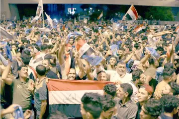  ??  ?? Iraqi supporters of Sairun list celebrate after results of Iraq’s parliament­ary election were announced in Baghdad. — Reuters photo