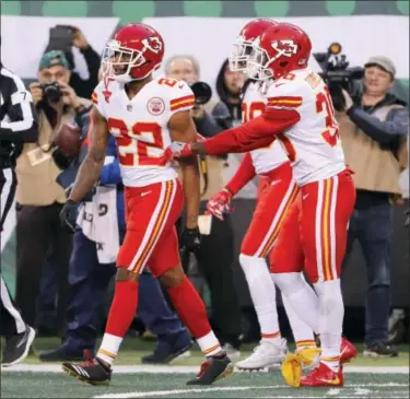  ?? JULIE JACOBSON — THE ASSOCIATED PRESS ?? Teammates of Kansas City Chiefs’ Marcus Peters, left, try to prevent him from leaving the field after a penalty during the second half of the team’s NFL football game against the New York Jets, Sunday in East Rutherford, N.J.