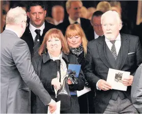  ??  ?? HEARTBROKE­N Tommy’s wife Mary leaves the service at Daldowie Crematoriu­m