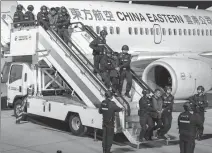  ?? YIN GANG / XINHUA ?? Ten major crime suspects, including six suspected of orchestrat­ing telecom fraud against Chinese people from northern Myanmar, are escorted to Kunming, Yunnan province, on Jan 30, after being returned to China by Myanmar police.