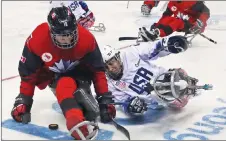  ?? AP PHOTO ?? Canada’s Ben Delaney keeps the puck away from United States’ Rico Roman during the gold-medal match at the Winter Paralympic­s in Gangneung, South Korea.