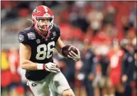  ?? Mike Zarrilli / Getty Images ?? Tight end John Fitzpatric­k of the Georgia Bulldogs runs with the ball after making a reception during the Chick-fil-A Peach Bowl against the Cincinnati Bearcats at Mercedes-Benz Stadium on Friday in Atlanta. Georgia won 24-21.