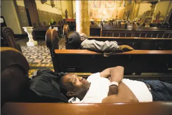  ?? Photos by Noah Berger / Special to The Chronicle ?? Anthony Wilburn rests at St. Boniface Catholic Church, where Project Gubbio lets homeless people sleep in pews on weekdays. One, William Ellis, collapsed there on April 6.