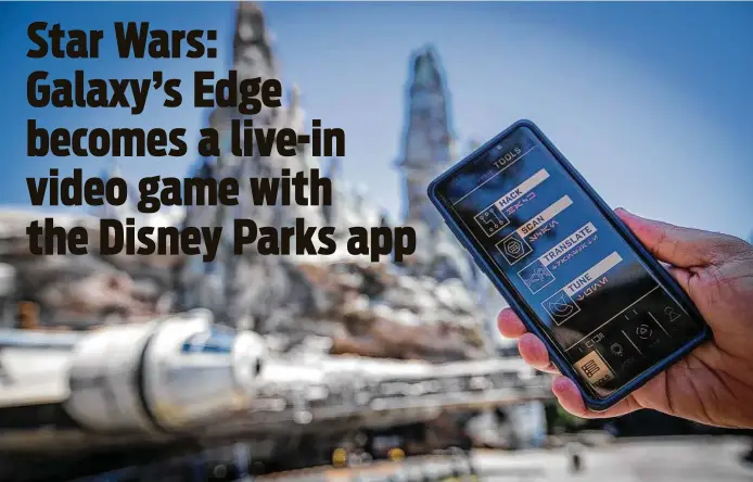  ?? Photos by Allen J. Schaben / Los Angeles Times ?? Star Wars: Galaxy's Edge becomes a walk-around video game to guests using the Datapad app. It’s essentiall­y an attraction that uses the land as a giant game board.