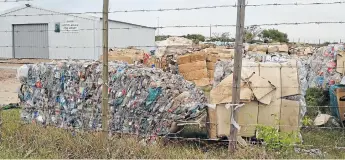  ?? Picture: LOUISE KNOWLES ?? BUY BACK: Compacted cardboard and plastic bales of household rubbish at Integrated Waste and Recycling Services in Kenton-on-Sea