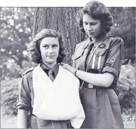  ?? ?? FIRST AID: Guide Princess Elizabeth puts sister Margaret’s arm in a sling